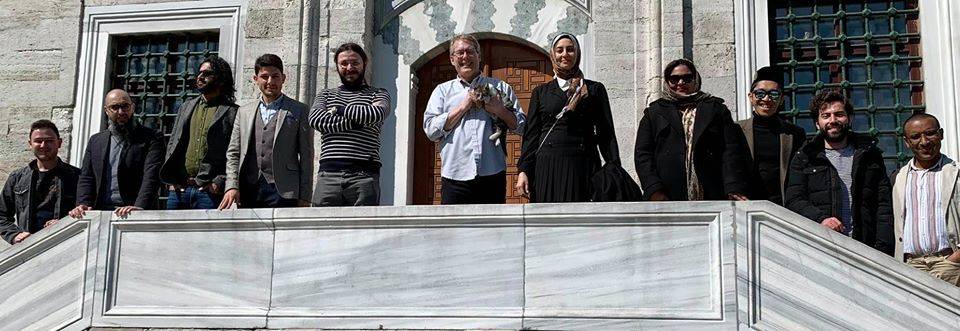 Group shot in front of mosque